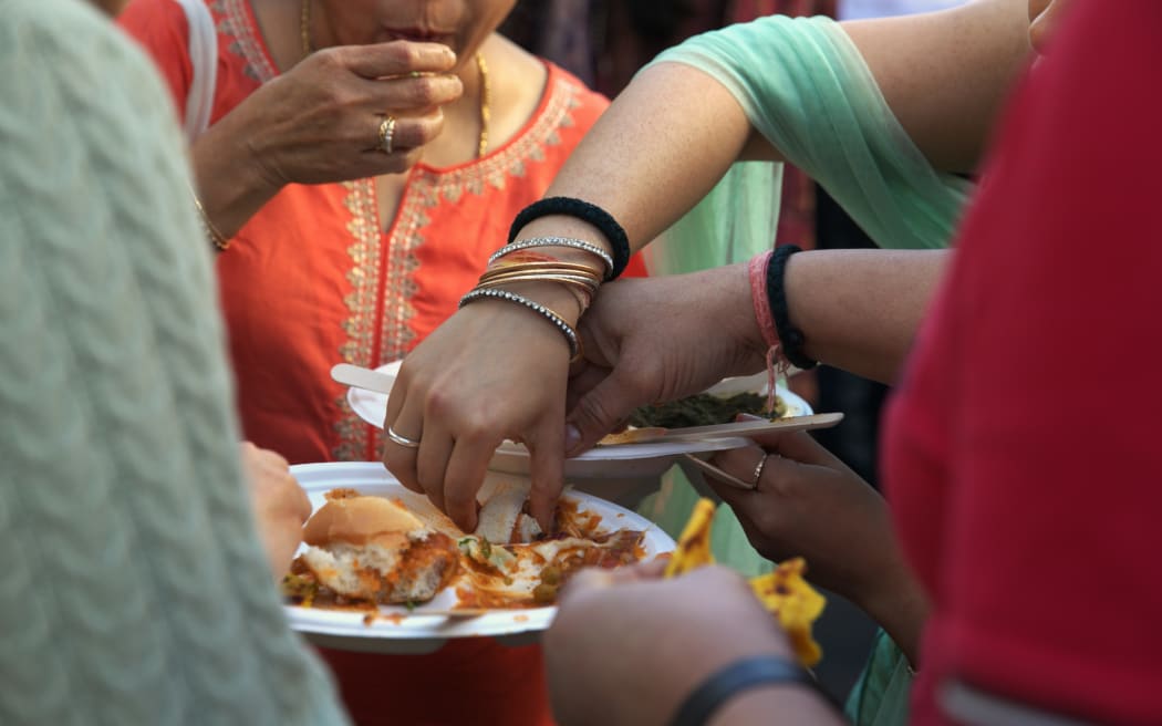 Visitors share plates of Indian street food at the 2023 BNZ Auckland Diwali Festival.