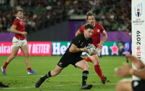 Beauden Barrett foes in for his try in the Rugby World Cup match against Canada.