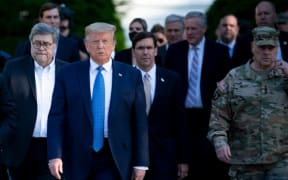 US President Donald Trump walks with Attorney General William Barr, left, Secretary of Defense Mark T. Esper, centre, Chairman of the Joint Chiefs of Staff Mark A. Milley, right, and others to visit St John's Church after the area was cleared of protesters, on 1 June.