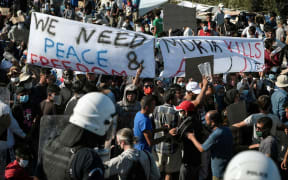 Refugees and migrants from the destroyed Moria camp protest to call for their resettlement in front of a police blockade near the town of Mytilene and the Kara Tepe camp, on 11 September 2020, on the island of Lesbos.