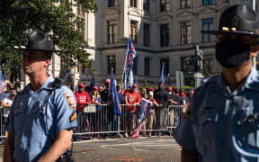 Officers stand between the protesters and counter protesters as supporters of Donald Trump host a 'Stop the Steal' protest outside of the Georgia State Capital building on November 21, 2020 in Atlanta, Georgia.