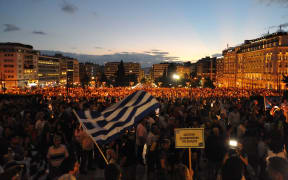 GREECE, Athens: Protesters turn out in droves to Syntagma Square outside the Parliament of Greece on June 18, 2015, demanding that Greece remain in the European Union and urging the Syriza government to reach agreement with lenders.